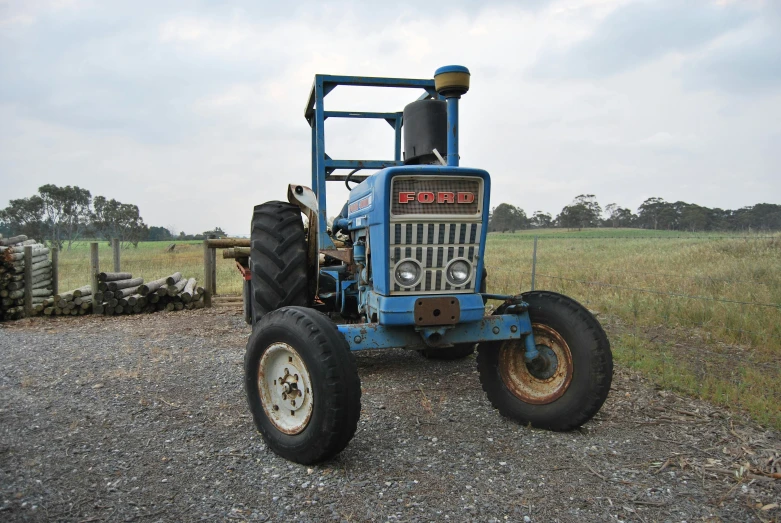 this is a tractor parked in the gravel