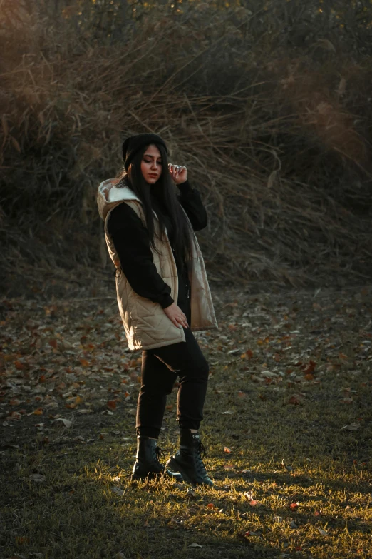 a woman is standing outside in the fall