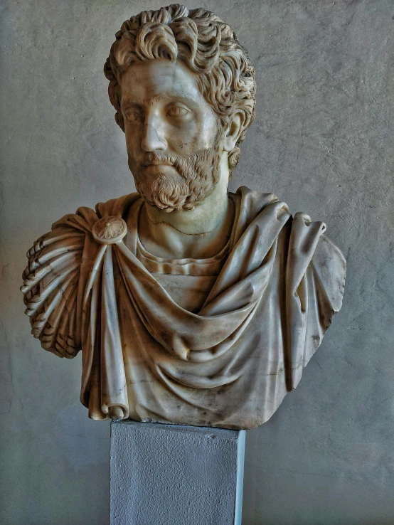 a marble busturine with his hair up and dressed