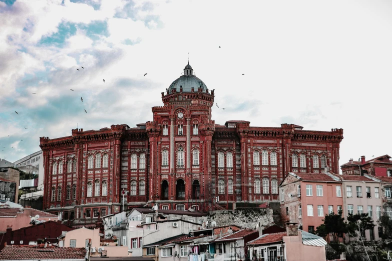 the big building is in front of some very colorful buildings