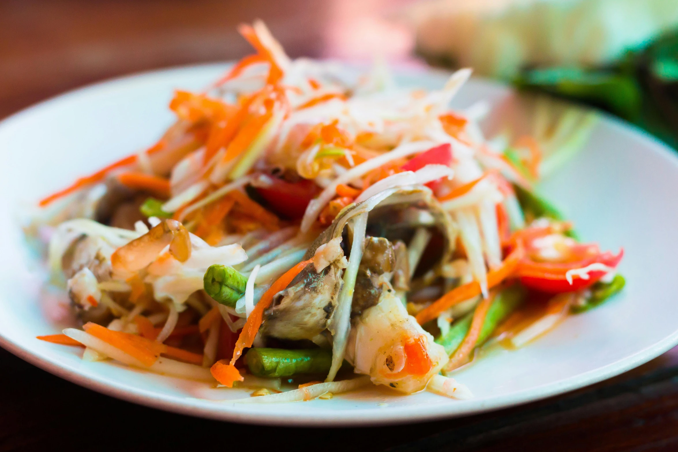 a dish of food with carrots, onions and meat