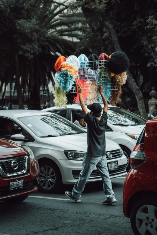 a man that is walking next to some cars