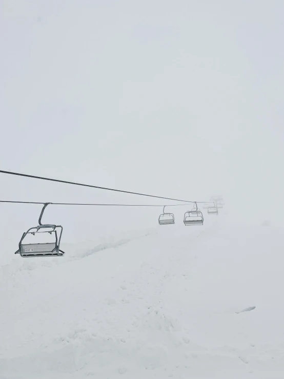 people riding the ski lift at a ski slope