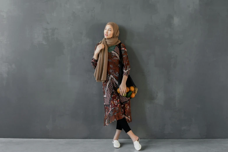 a woman in a dress walking up the stairs