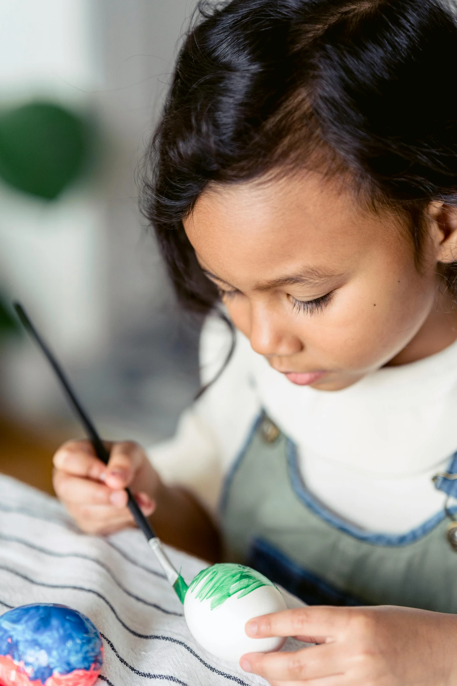 a  is painting a colorful object