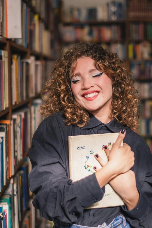 a woman in a liry holding a book smiling