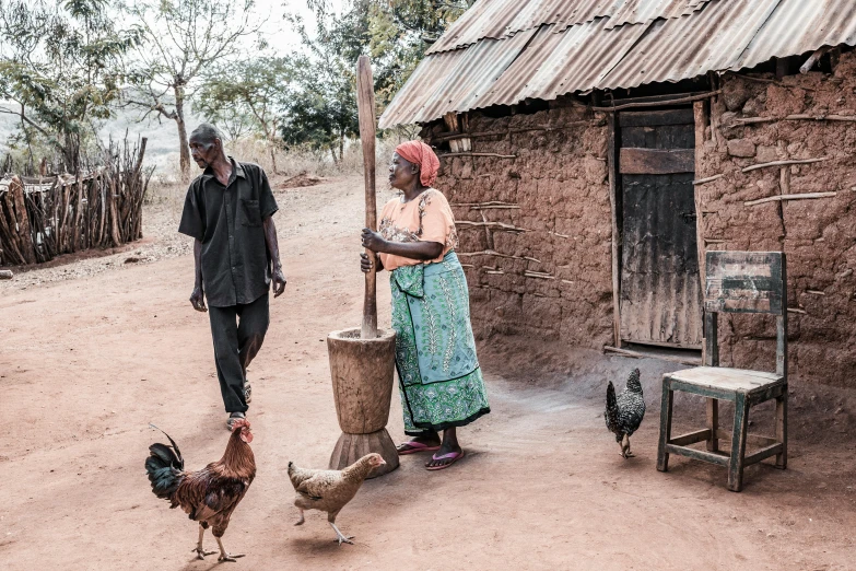 two people walking around in their rural village