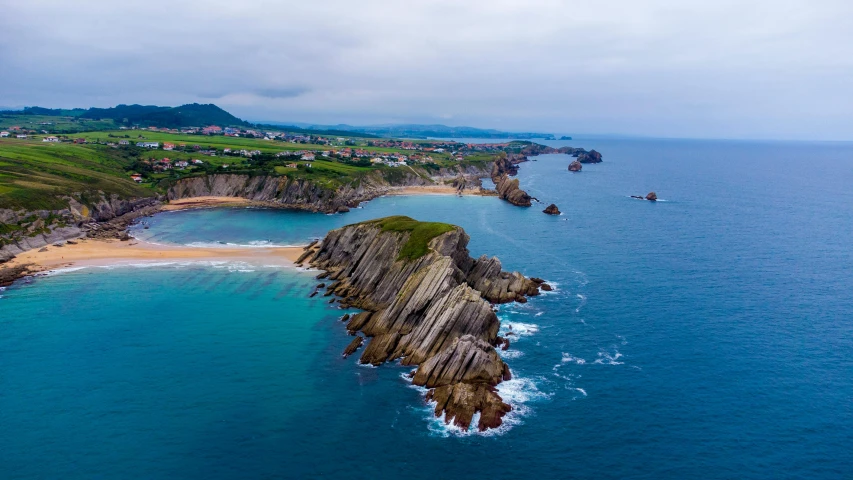 an aerial view of a beautiful landscape with ocean waves