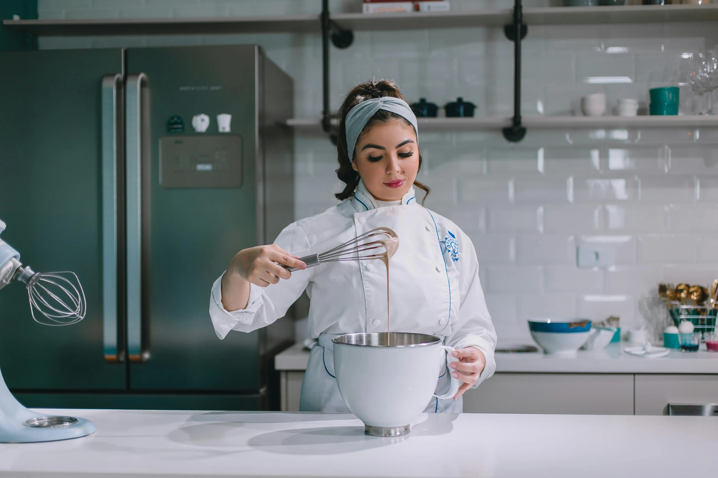 a person standing in front of a mixing bowl