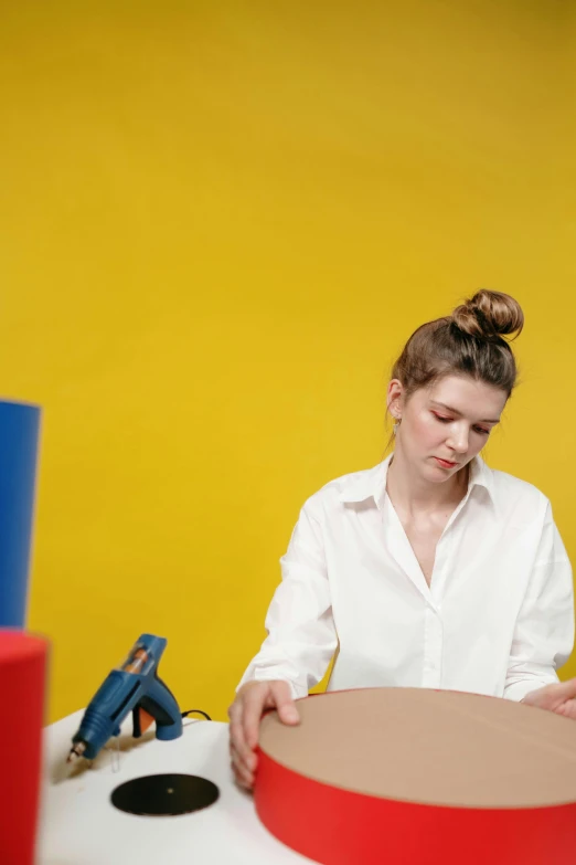 a girl is working on the side of her desk