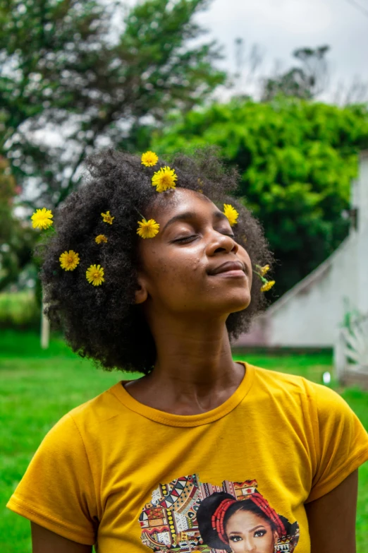 a woman with her head resting on yellow flowers