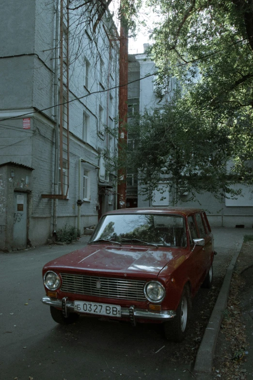 a red station wagon on the side of the street