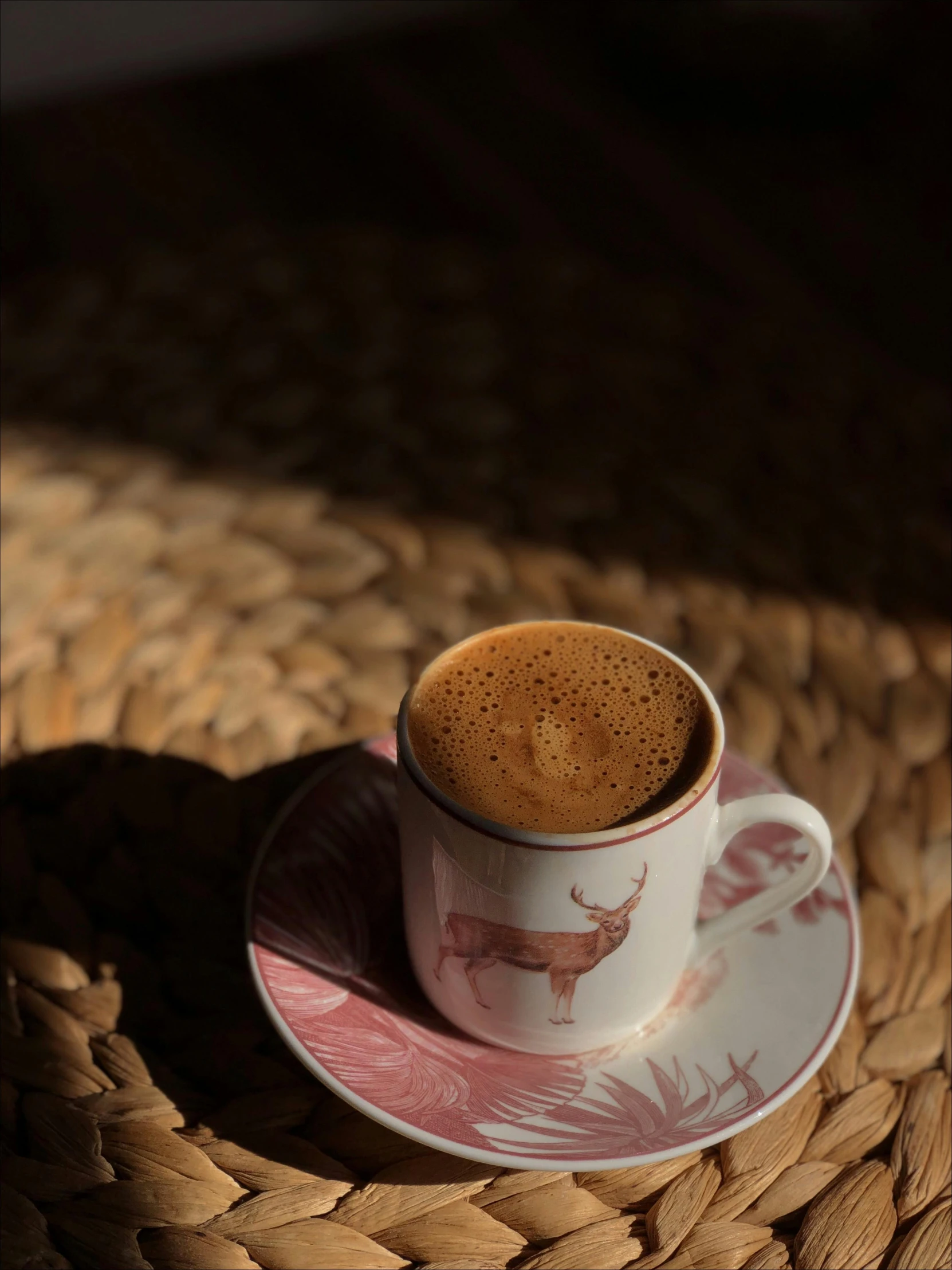 coffee in a cup on a saucer on a woven table cloth