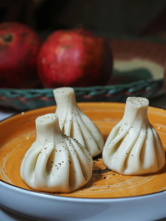 some tiny white food items are on a plate