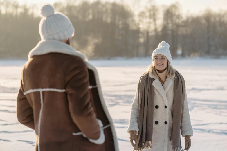 the two people are wearing jackets in the snow