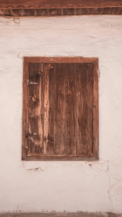 a small window is made from brown wood