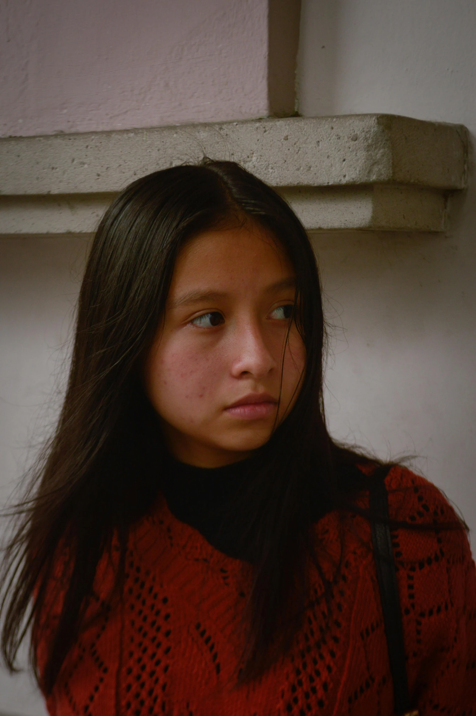 a woman in a red sweater and a handbag