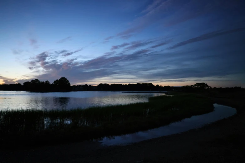 a lake with a sky line in the background