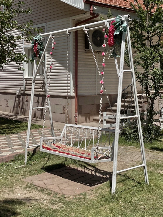 a swing that is leaning to the side with decorations on it