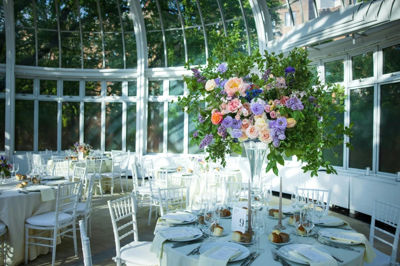 a large vase filled with flowers sitting on top of a table