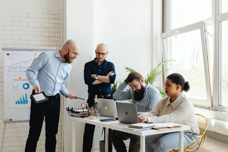 an image of a group of people working on a laptop