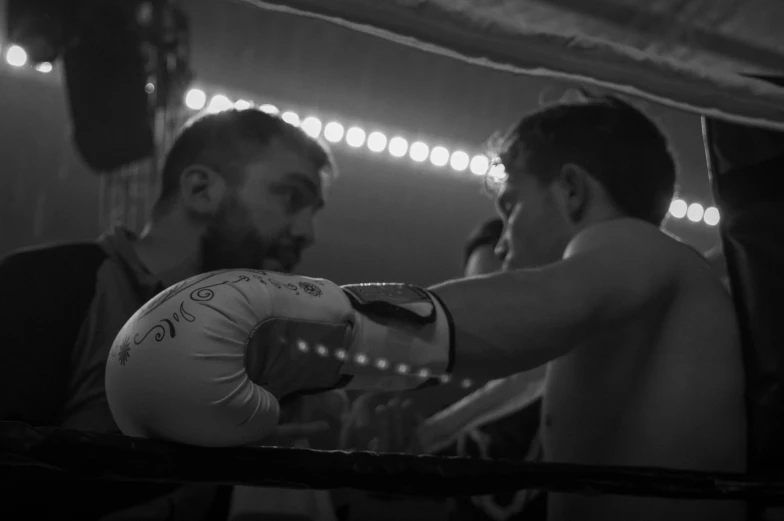 a man is preparing to spar with a punching glove