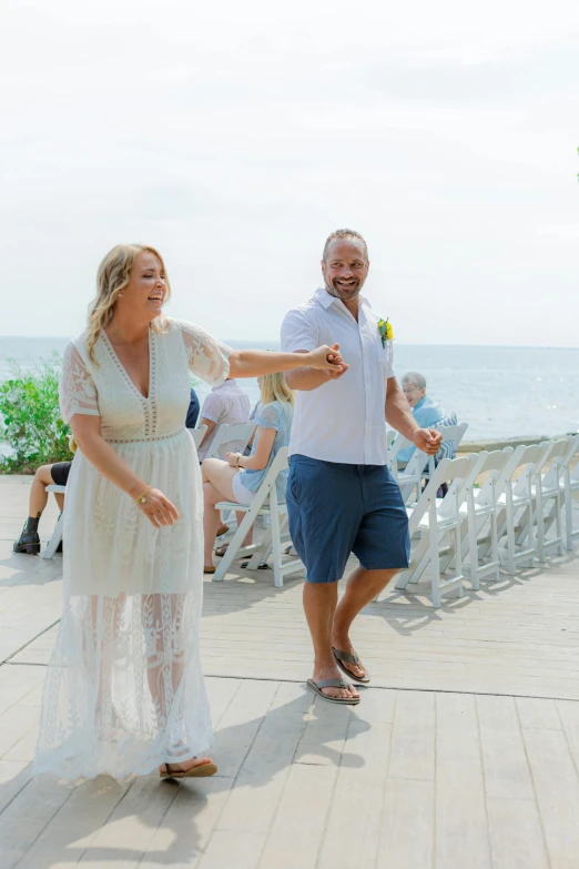 a man and a woman dance on the boardwalk