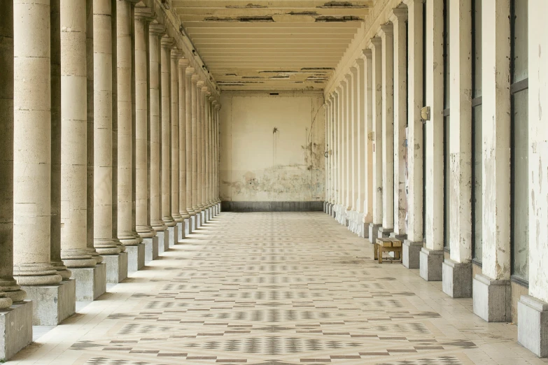 a long hallway filled with columns and some floor