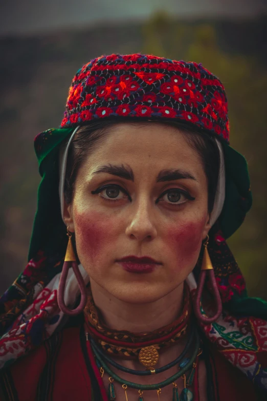 the woman is wearing a red and green head dress