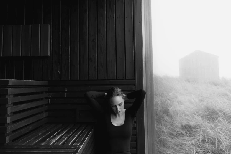 a person leaning against a wooden fence