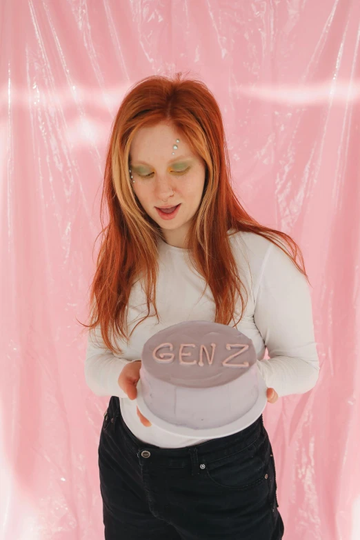 a redhead woman holding a toy hat with the words genz written on it