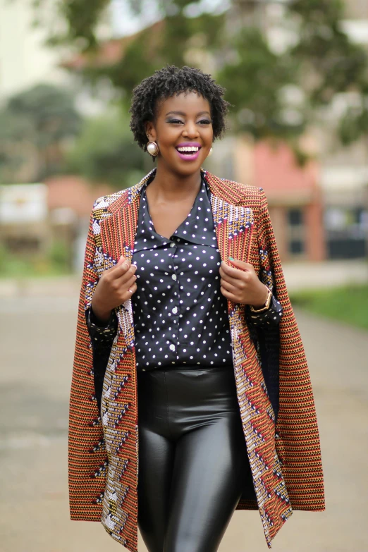 a beautiful young lady walking down a path with a polka dotted shirt