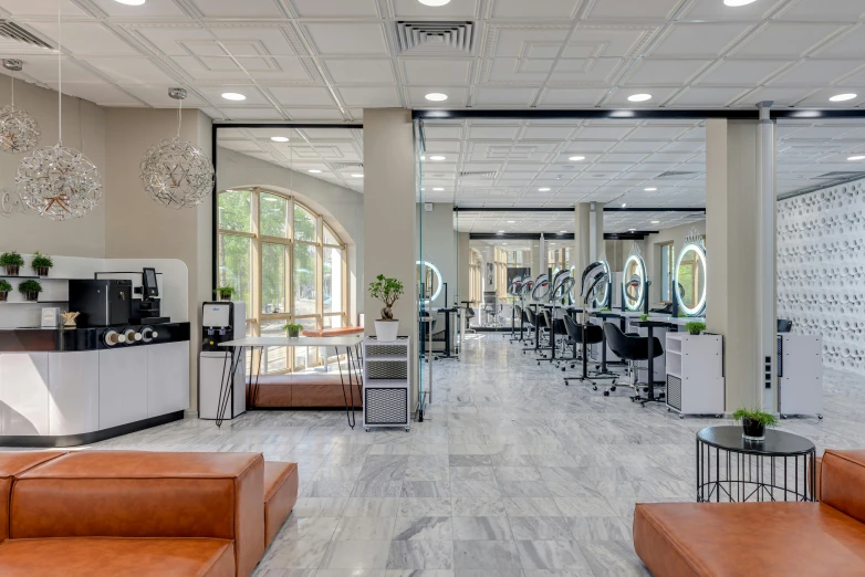 there is a salon with mirrors, sofas and chairs