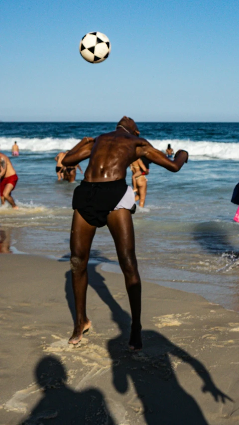 man jumping in the air as he plays with a soccer ball