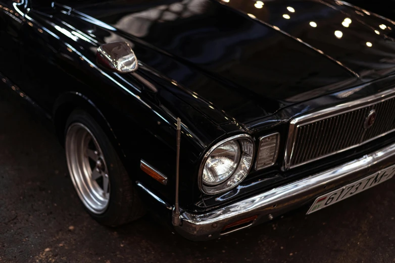 a classic black mustang parked on a street