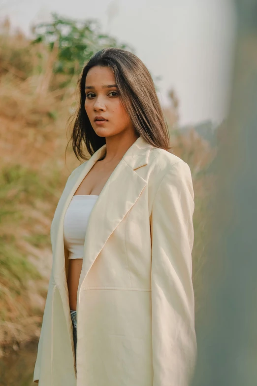 woman in white suit posing for po