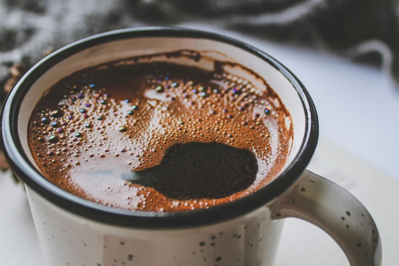 a brown drink with chocolate, cream and sprinkles