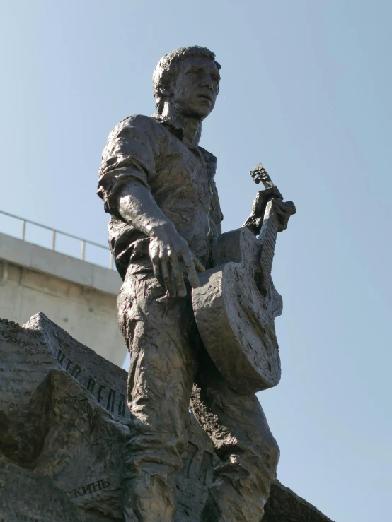 a statue of a man holding a guitar