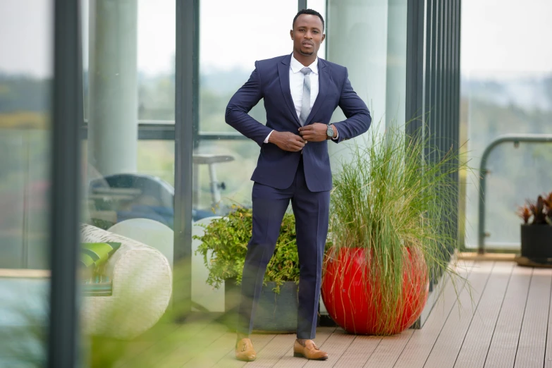 an african american man standing next to tall grass