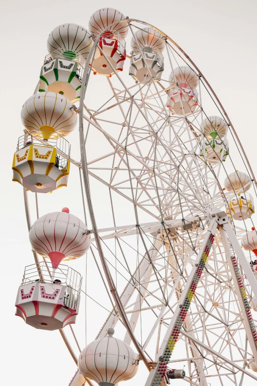 a ferris wheel with various colored objects hanging from it