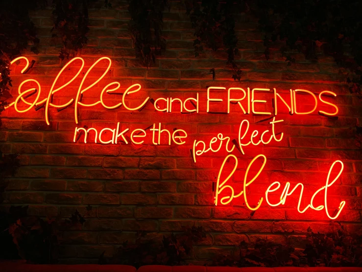 a red neon sign hanging on the side of a wall