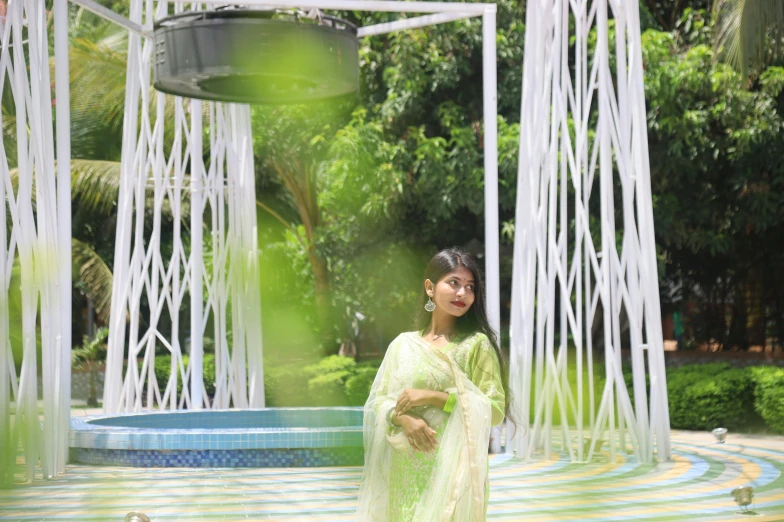 a young lady standing in front of a fountain