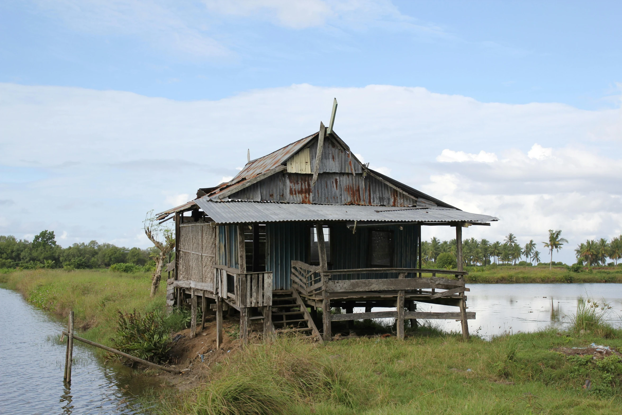 a very old wooden boat house next to a body of water