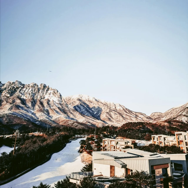 a view of the snow covered mountains with buildings