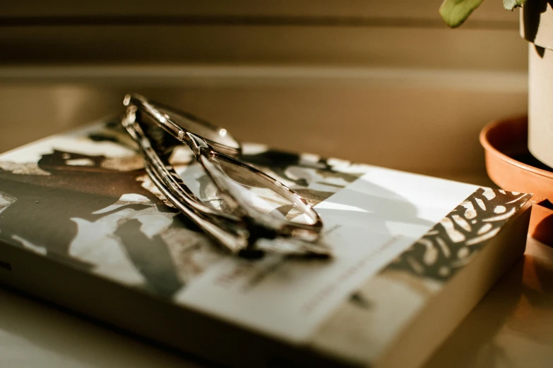 a stack of scissors and a book on a table