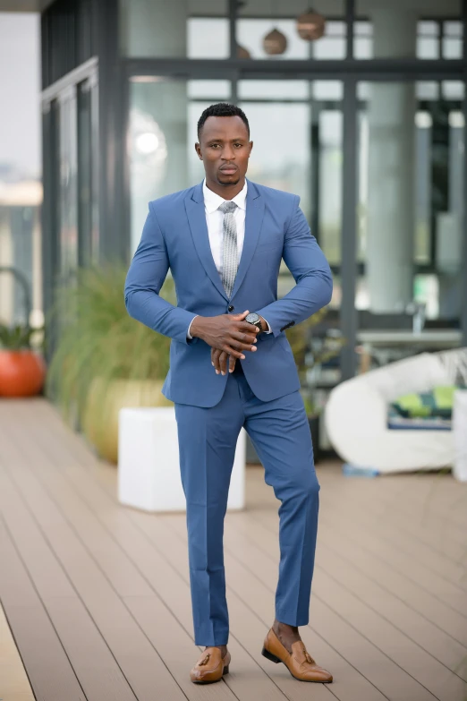 a man in a blue suit posing for a picture