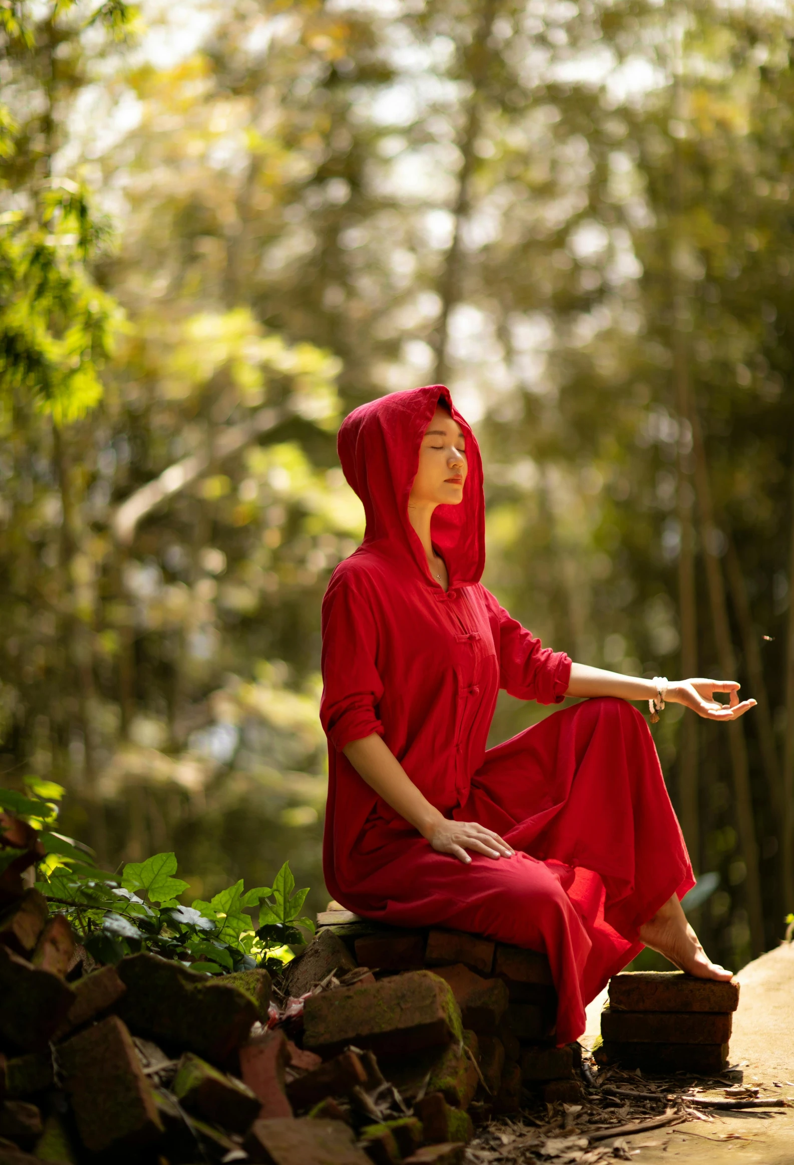 a woman in a red robe and red head scarf sitting down