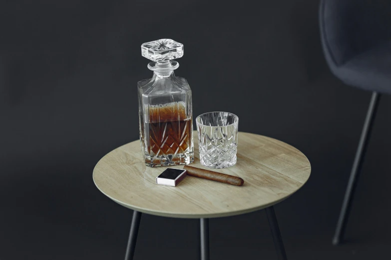 a table with a bottle and two glasses