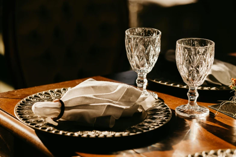 a glass and glass plate with glasses on the table