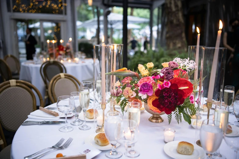 a table that has some glasses and candles on it